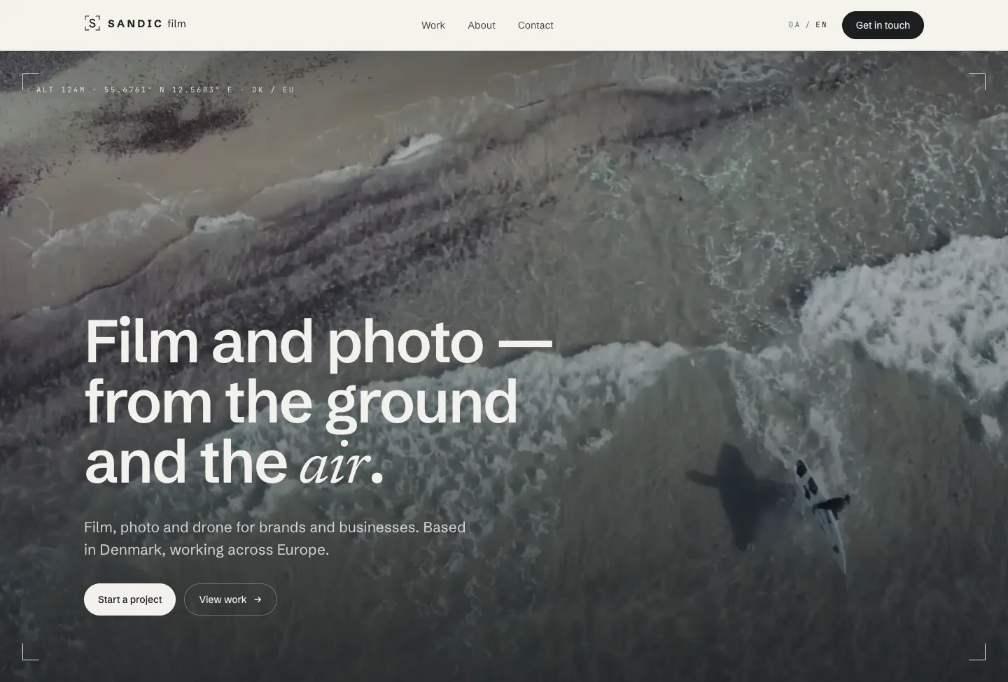 Sandic Film website: the headline “Film and photo — from the ground and the air.” over an aerial shot of a surfer in the waves.